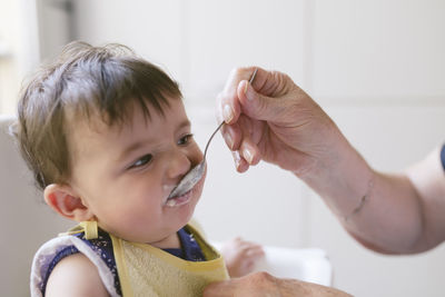 Portrait of baby girl after feeded by grandmother