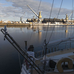 Boats moored on shore against sky