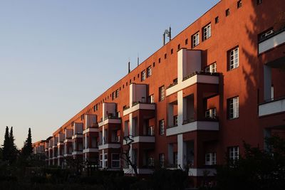 Low angle view of bauhaus style housing estate against evening sky