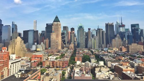 Cityscape against cloudy sky