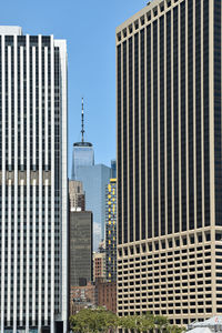 Modern buildings in city against clear sky