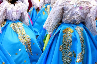 Midsection of women wearing evening gowns