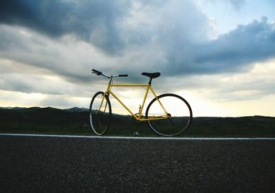 Bicycle on road against sky