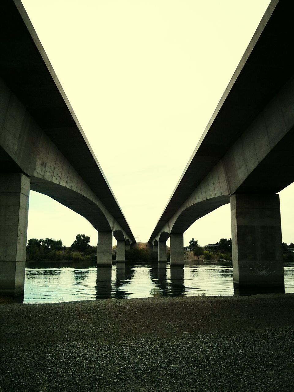 connection, bridge - man made structure, built structure, architecture, engineering, bridge, transportation, water, river, clear sky, suspension bridge, long, sky, low angle view, architectural column, support, travel destinations, outdoors, city, arch