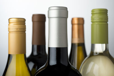 Close-up of bottles against white background