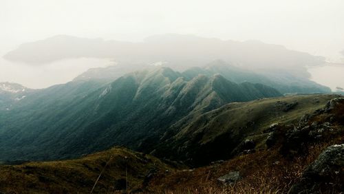 Scenic view of mountains against cloudy sky