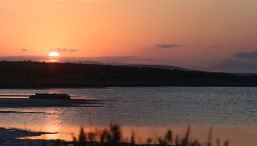 Scenic view of sea against romantic sky at sunset