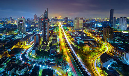 High angle view of illuminated city buildings at night