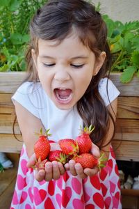 Close-up of girl holding fruits