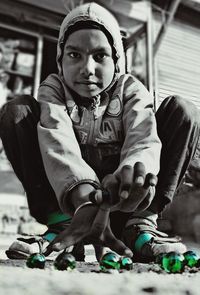 Portrait of young man sitting outdoors