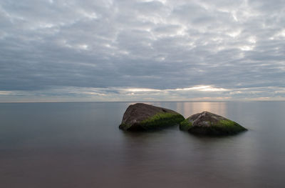 View of calm sea against cloudy sky