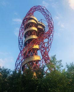 Low angle view of illuminated ferris wheel against sky