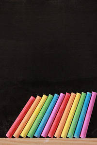 Close-up of multi colored pencils against black background