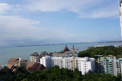 High angle view of buildings and sea against sky