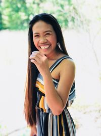 Portrait of smiling young woman with long hair