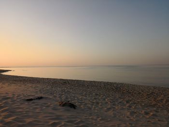 Scenic view of beach against sky during sunset