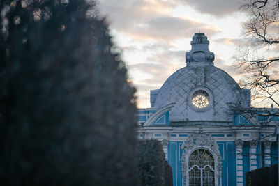 Low angle view of clock tower against sky at dusk