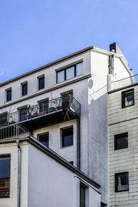 Low angle view of building against clear blue sky