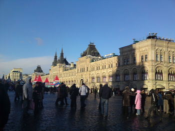 People at red square with gum against sky
