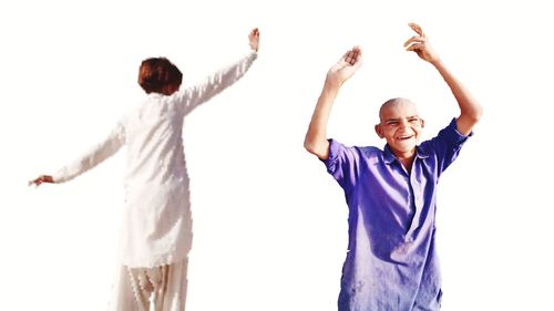 Happy friends standing against white background