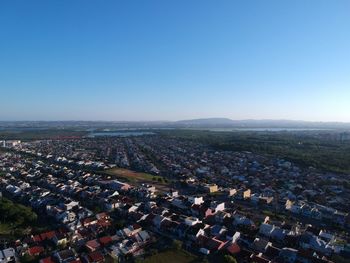 High angle view of townscape against clear blue sky