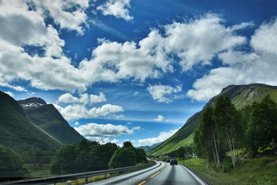 Road passing through mountains against sky