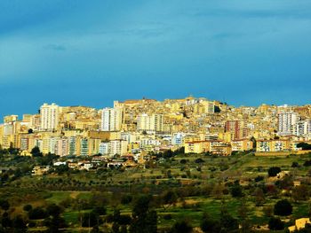 View of cityscape against blue sky