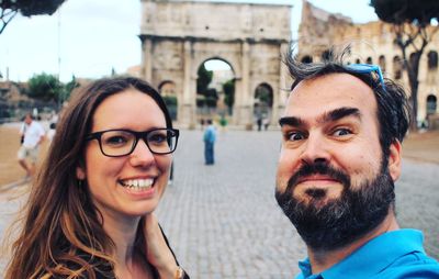 Portrait of smiling couple in city