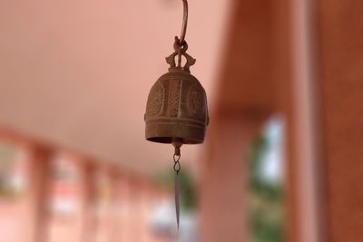 Close-up of light bulbs hanging against building