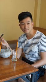 Portrait of smiling man sitting at restaurant