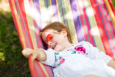 Portrait of cute girl lying outdoors