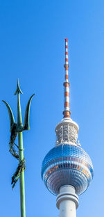 Low angle view of communications tower against sky