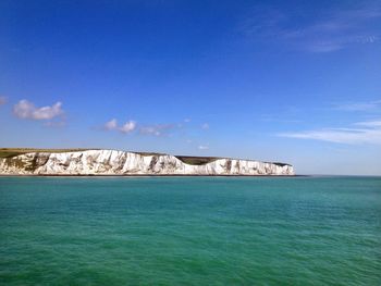Idyllic shot of white cliffs of dover against sky