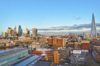 View of cityscape against blue sky during sunset