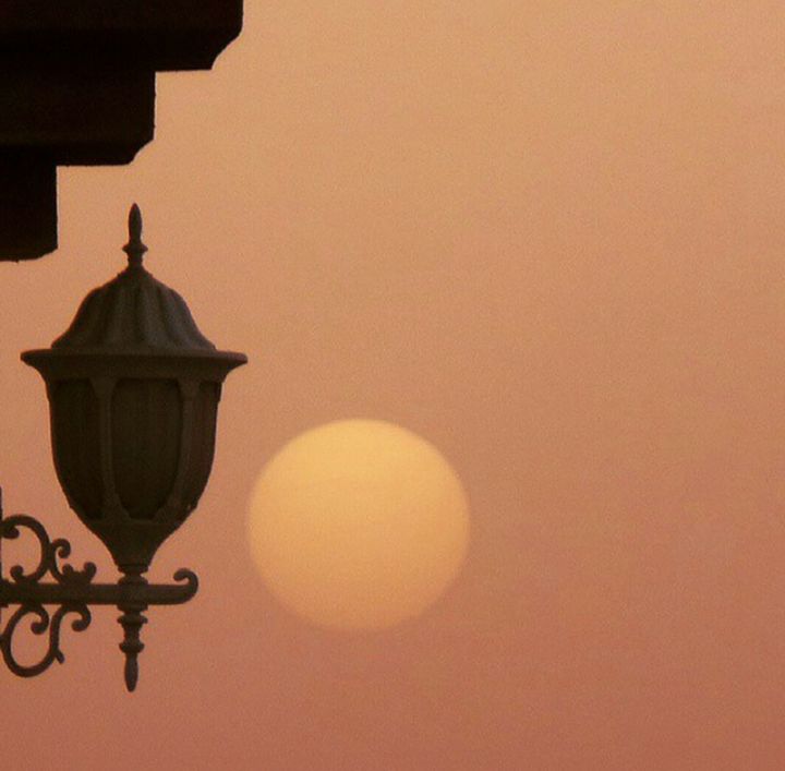 LOW ANGLE VIEW OF STREET LIGHT AT SUNSET