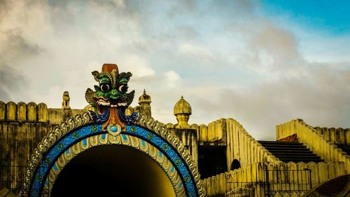 Low angle view of built structure against cloudy sky