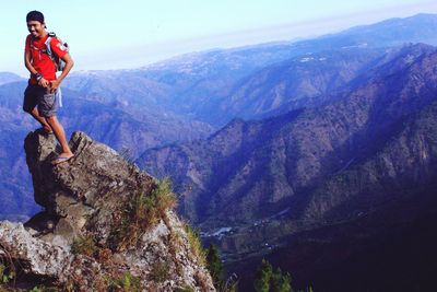 Full length of hiker standing on mountain