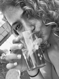 Close-up portrait of a woman drinking glass