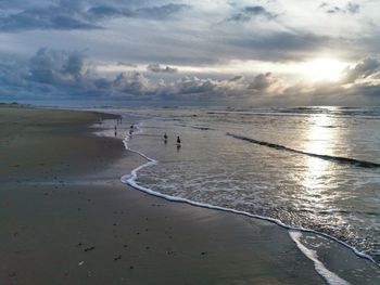 Scenic view of beach against sky during sunset