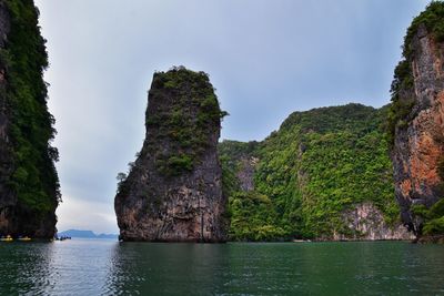 Rock formations by sea against sky