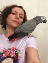Portrait of woman wearing bird