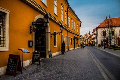 Street amidst buildings in city against sky