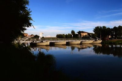 Built structure by trees against sky