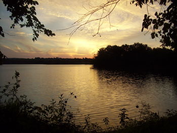 Scenic view of lake against sky at sunset