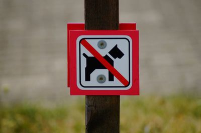 Close-up of road sign on wooden post