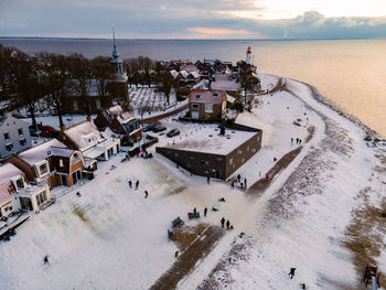 High angle view of people in city by sea during winter