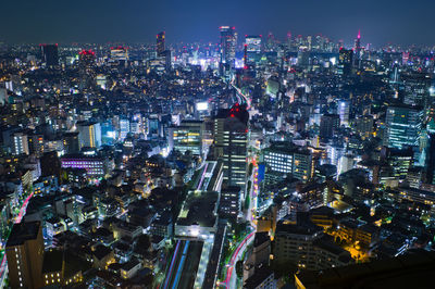 High angle view of illuminated city buildings at night