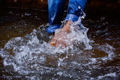 Low section of man splashing water