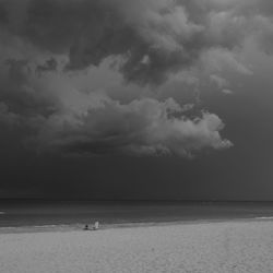 Scenic view of sea against storm clouds