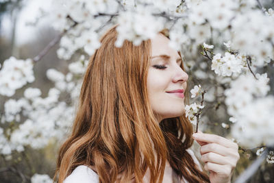 Portrait of woman with red flowers